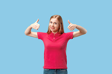 Image showing The happy business woman standing and smiling against blue background.