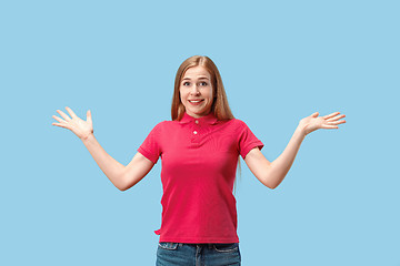 Image showing The happy business woman standing and smiling against blue background.