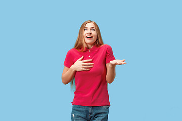 Image showing Beautiful woman looking suprised isolated on blue