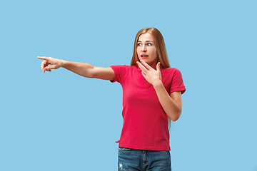 Image showing The happy business woman point you and want you, half length closeup portrait on blue background.