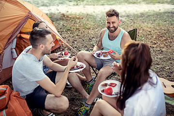 Image showing Party, camping of men and women group at forest. They relaxing and eating barbecue