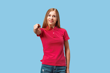 Image showing The happy business woman point you and want you, half length closeup portrait on blue background.