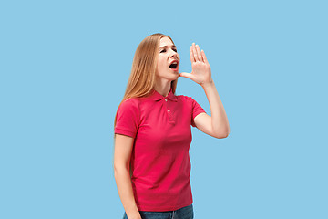 Image showing Isolated on pink young casual woman shouting at studio