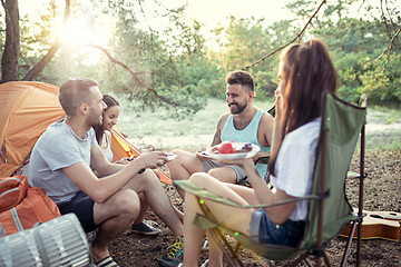 Image showing Party, camping of men and women group at forest. They relaxing and eating barbecue