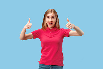 Image showing The happy business woman standing and smiling against blue background.