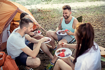 Image showing Party, camping of men and women group at forest. They relaxing and eating barbecue