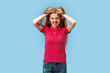 Image showing The young emotional angry and scared woman standing and looking at camera