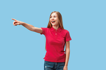 Image showing The happy business woman point you and want you, half length closeup portrait on blue background.