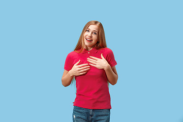 Image showing The happy business woman standing and smiling against blue background.