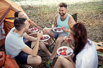 Image showing Party, camping of men and women group at forest. They relaxing and eating barbecue