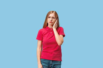 Image showing Woman having headache. Isolated over blue background.