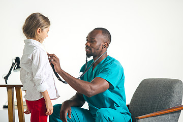 Image showing healthcare and medical concept - doctor with stethoscope listening to child chest in hospital