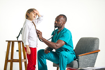 Image showing healthcare and medical concept - doctor with stethoscope listening to child chest in hospital