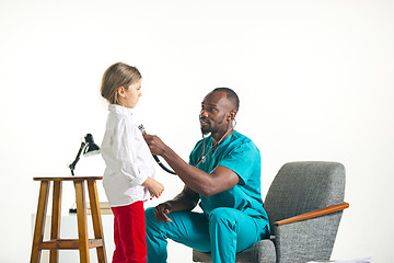 Image showing healthcare and medical concept - doctor with stethoscope listening to child chest in hospital
