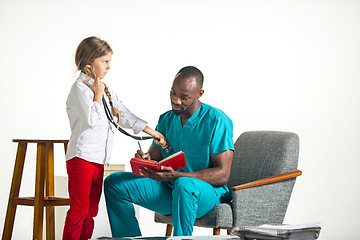 Image showing healthcare and medical concept - doctor and girl with stethoscope in hospital