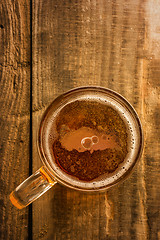 Image showing turkish beer concept, Turkey silhouette on foam in beer glass on wooden table.