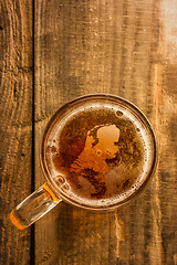 Image showing Dutch beer concept, Netherlands silhouette on foam in beer glass on wooden table.