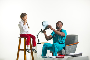 Image showing Young african male pediatrician explaining X-ray to child