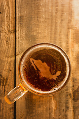 Image showing Mexican beer concept, Mexico silhouette on foam in beer glass on wooden table.