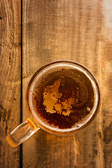Image showing Danish beer concept, Denmark silhouette on foam in beer glass on wooden table.