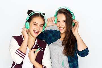 Image showing teenage girls in earphones listening to music