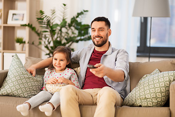 Image showing happy father and daughter watching tv at home