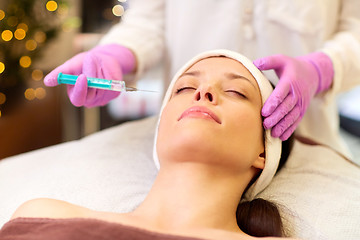 Image showing beautician doing beauty injection to woman lips