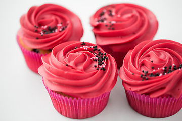 Image showing close up of cupcakes with red buttercream frosting