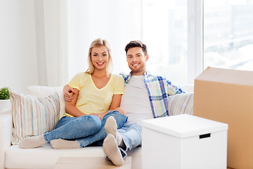 Image showing happy couple with boxes moving to new home