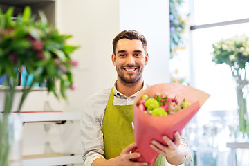 Image showing smiling florist man with bunch at flower shop