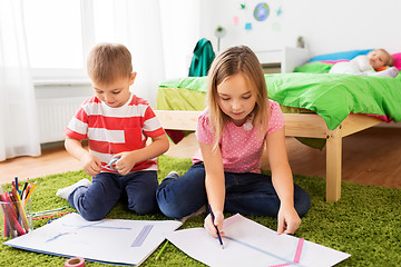 Image showing children drawing and making crafts at home