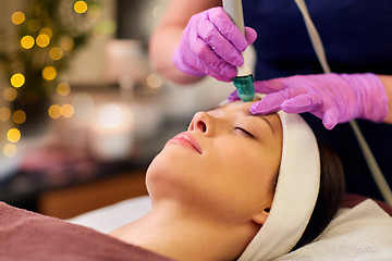 Image showing woman having microdermabrasion facial treatment