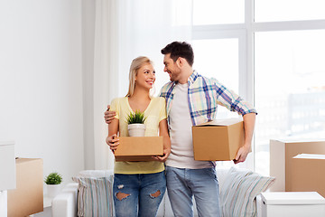 Image showing happy couple with boxes moving to new home