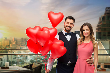 Image showing happy couple with red heart shaped balloons