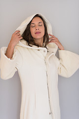 Image showing woman in a white coat with hood isolated on white background