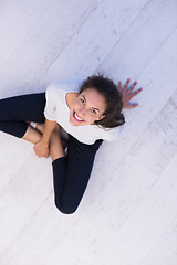 Image showing top view of young woman sitting on the floor