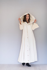 Image showing woman in a white coat with hood isolated on white background