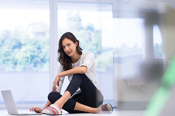 Image showing young women using laptop computer on the floor