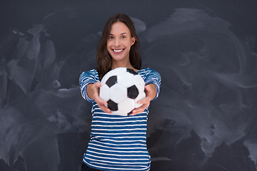 Image showing woman holding a soccer ball in front of chalk drawing board