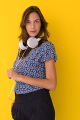 Image showing woman with headphones isolated on a yellow