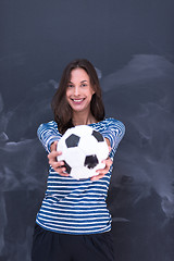 Image showing woman holding a soccer ball in front of chalk drawing board