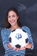 Image showing woman holding a soccer ball in front of chalk drawing board