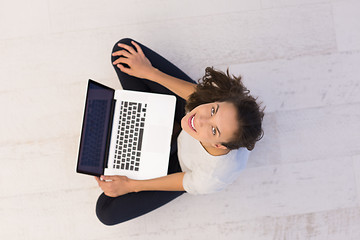 Image showing women using laptop computer on the floor top view