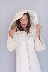 Image showing woman in a white coat with hood isolated on white background