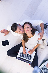 Image showing couple using tablet and laptop computers top view