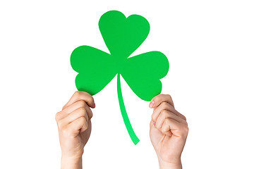 Image showing hands holding green paper shamrock