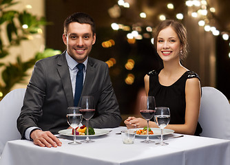 Image showing couple with food and red wine at restaurant