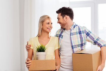 Image showing happy couple with boxes moving to new home