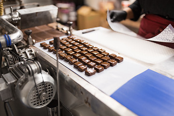 Image showing chocolate candies on conveyor at confectionery