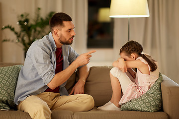 Image showing upset or feeling guilty girl and father at home